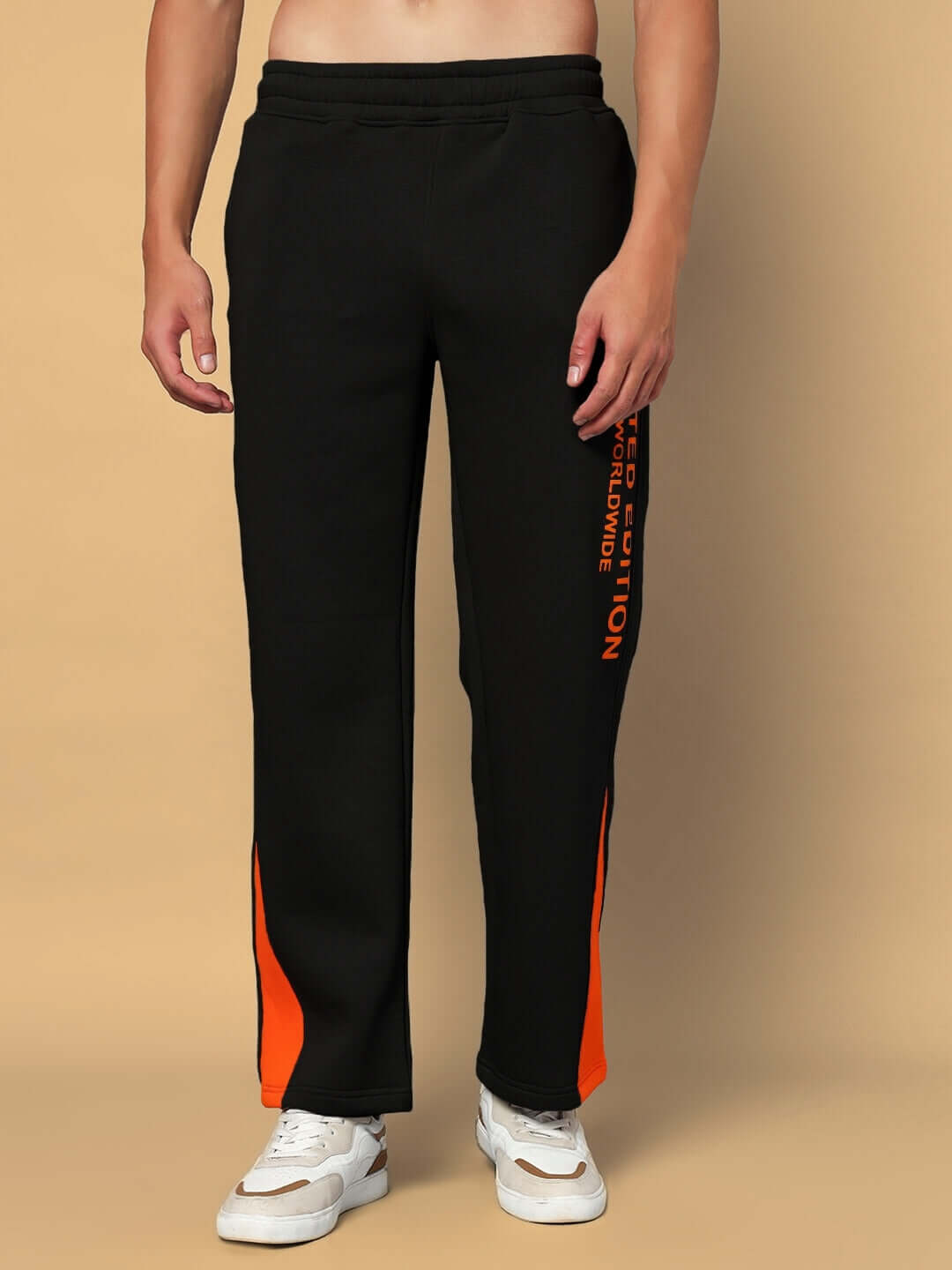 Black fleece joggers with orange side accents, perfect for casual wear, made-to-order by experienced tailors, offering custom fit options.