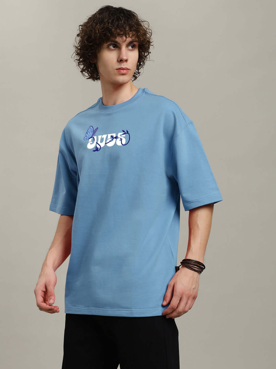 Model wearing light blue 'YOUR FEELING' printed t-shirt, crafted from premium cotton fabric, showcasing relaxed fit and modern design.