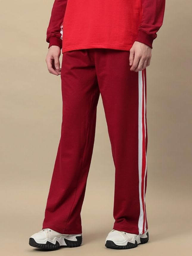 Model wearing maroon jogger pants with white side stripes, crafted by DUDS. Ideal for customization and tailored fit preferences.