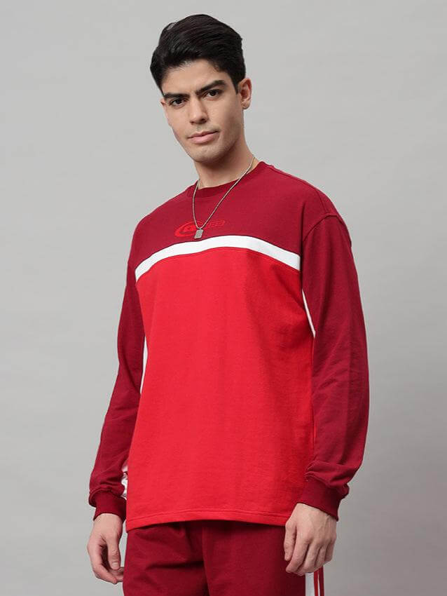 Man wearing a Zest oversized red sweatshirt made from premium cotton French terry, showcasing casual style and comfort.