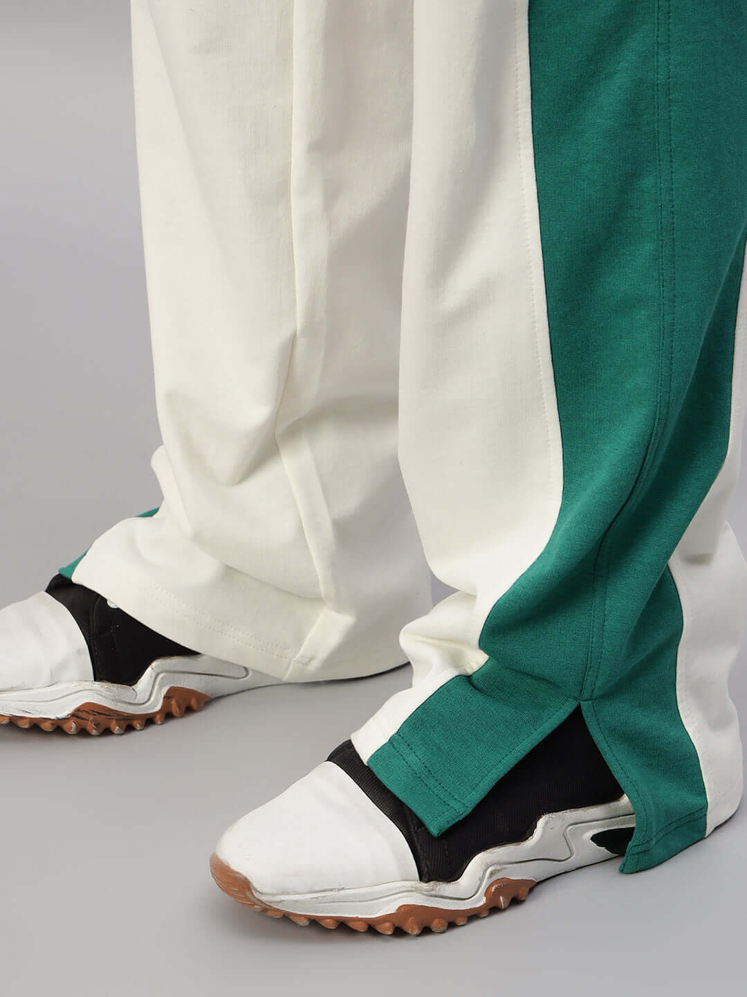Close-up of ZINGY OVERSIZED CO-ORD SET OFF WHITE TEAL joggers with contrast panel and shoes.