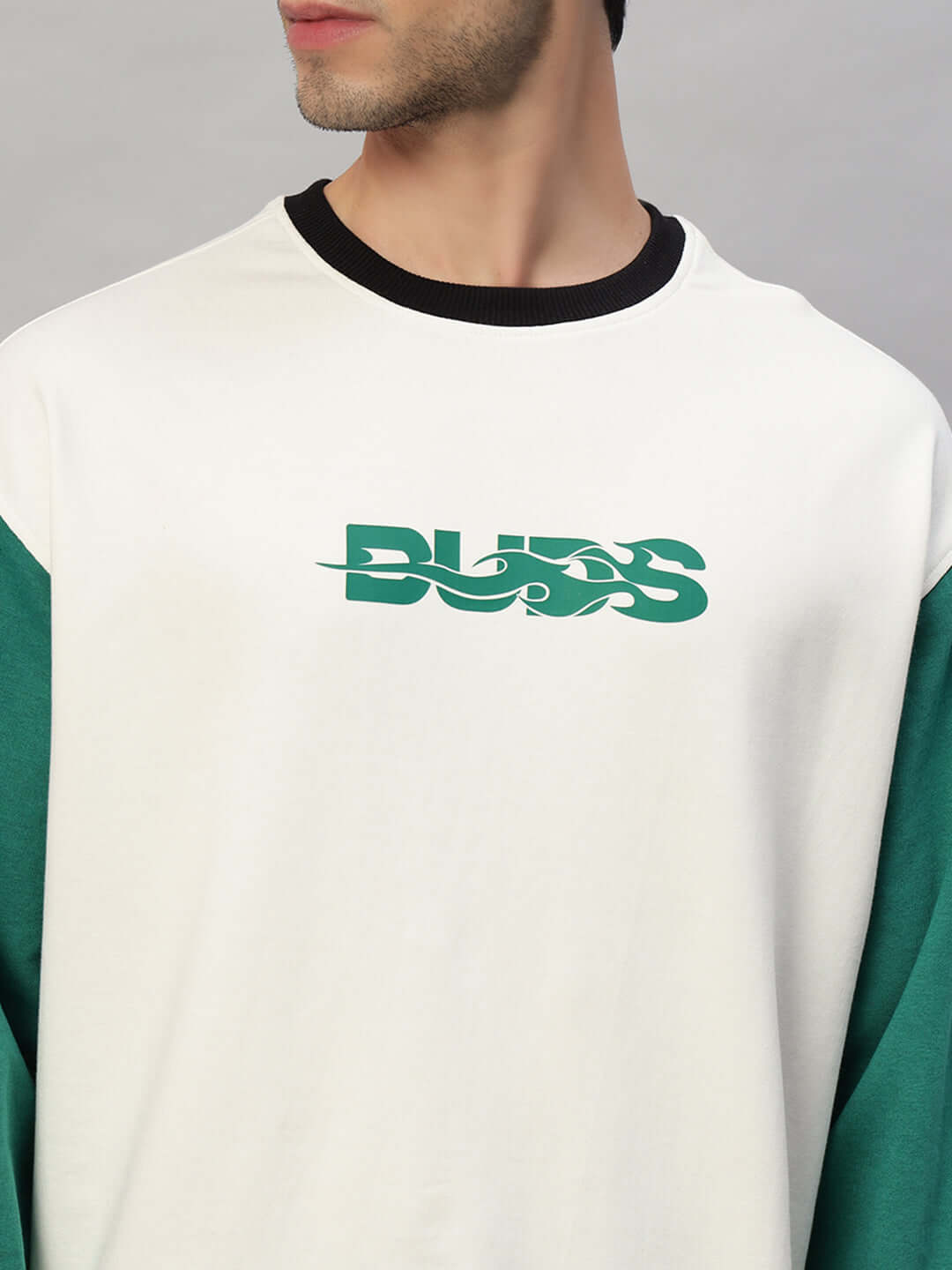 Model wearing Zingy oversized sweatshirt in off white and teal, featuring premium cotton fabric and BUDS logo, perfect for cold machine wash.
