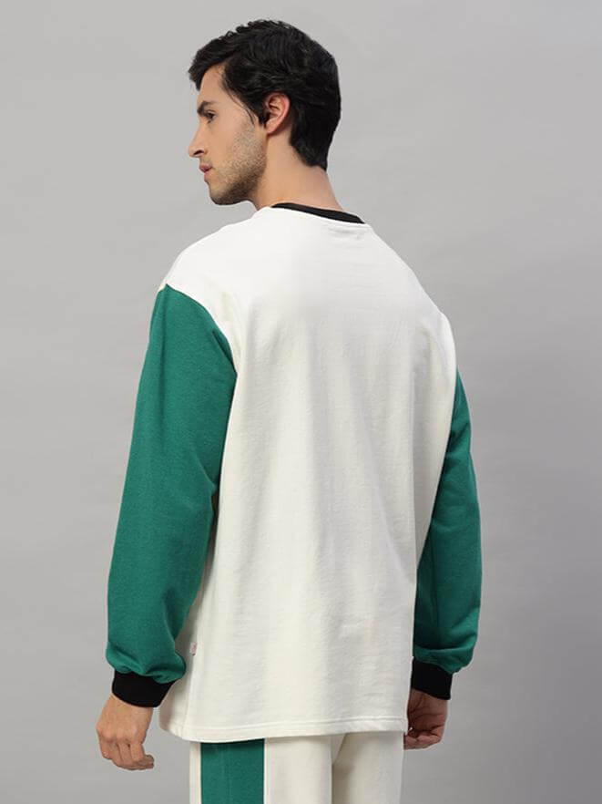 Back view of model wearing ZINGY oversized sweatshirt in off white and teal, made of premium cotton French terry, bio-washed.