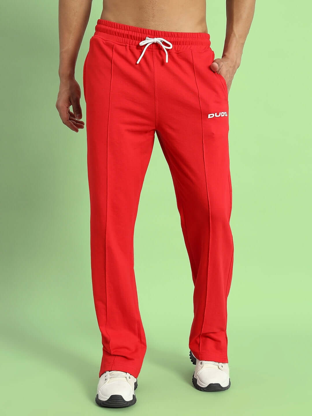 Model wearing ZION Side Slit Joggers in red with white drawstring by DUDS, showcasing comfortable fit and stylish design.