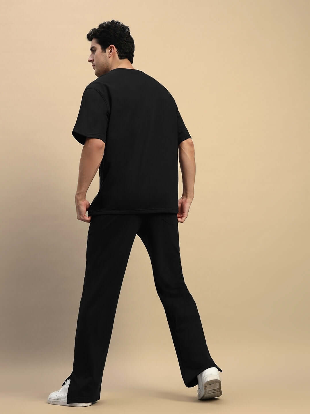 ZION Relaxed Fit Co-Ord Set in black featuring unisex joggers and t-shirt, made from premium cotton and elastane, shown from back view.