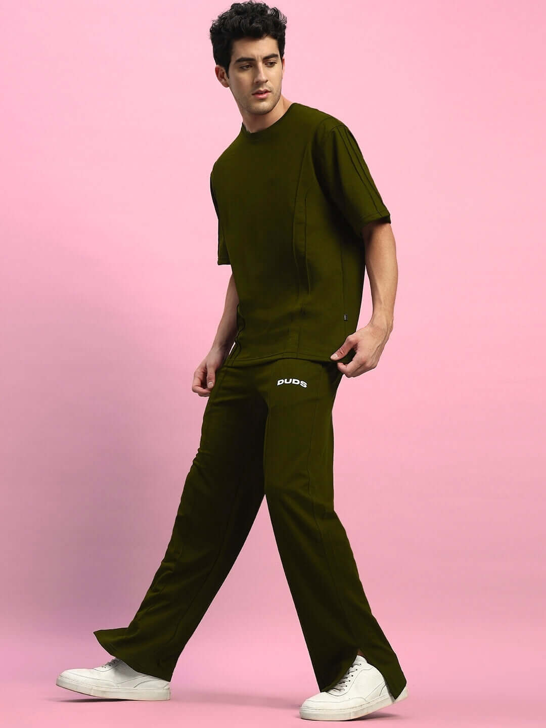 ZION Relaxed Fit Olive Green Co-Ord Set featuring unisex joggers and t-shirt, premium cotton, in stylish design on pink background.