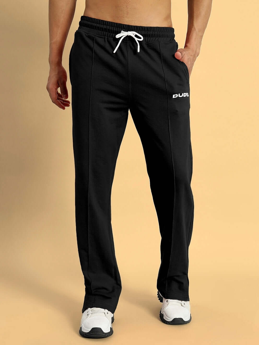 Model wearing black ZION SIDE SLIT JOGGERS by DUDS with drawstring waistband, ideal for custom fit orders.