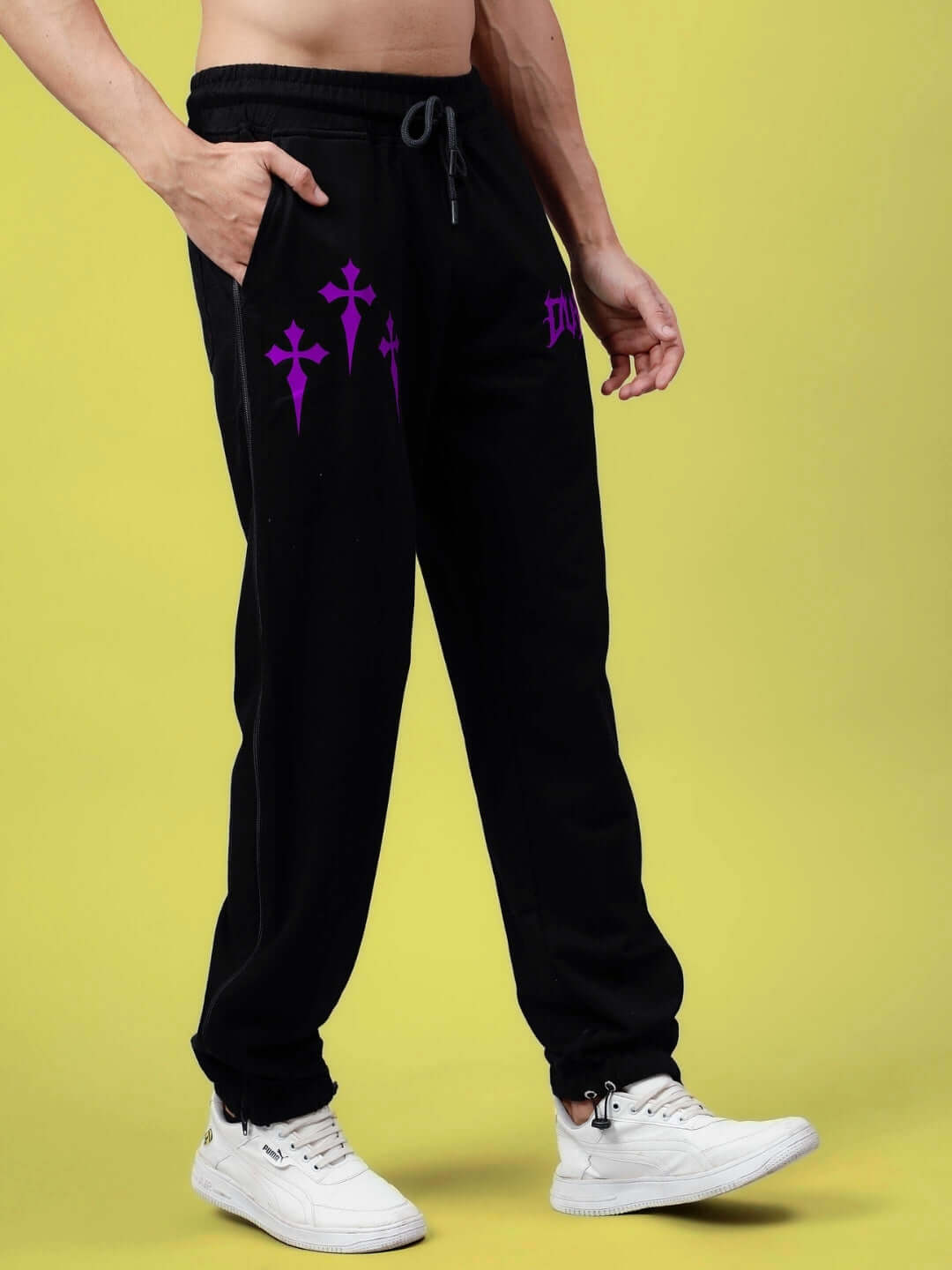 Person wearing black joggers with purple zipper panel, showcasing style and comfort for casual wear.