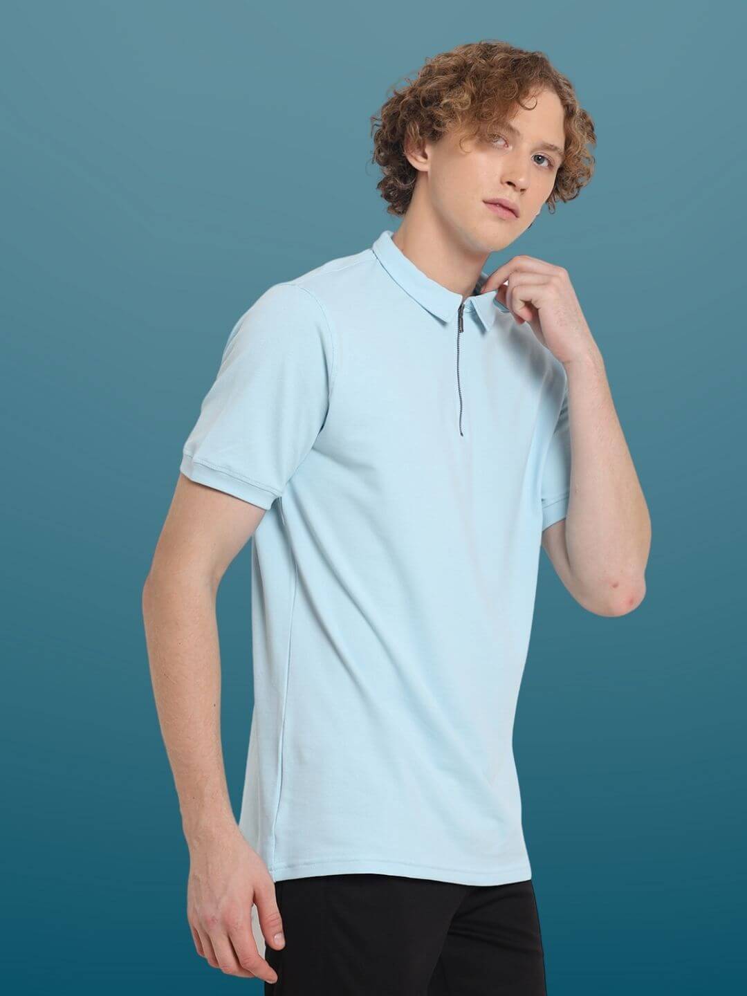 Man wearing a powder blue zipper polo neck t-shirt made from stretchy, wrinkle-free pique cotton with quick-dry feature.