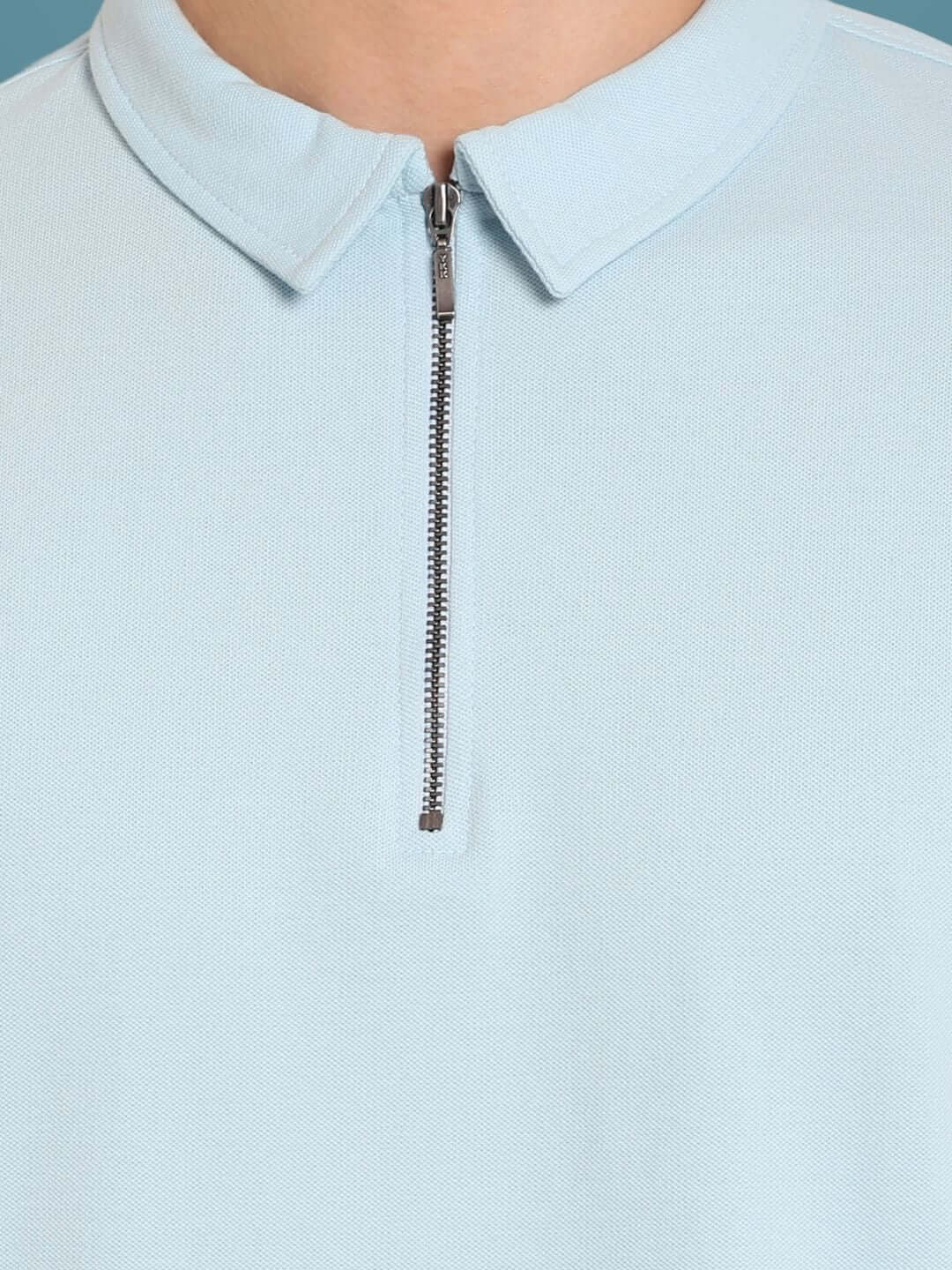 Powder blue zipper polo neck t-shirt made from sporty pique cotton lycra, featuring a sleek zipper for a modern look.