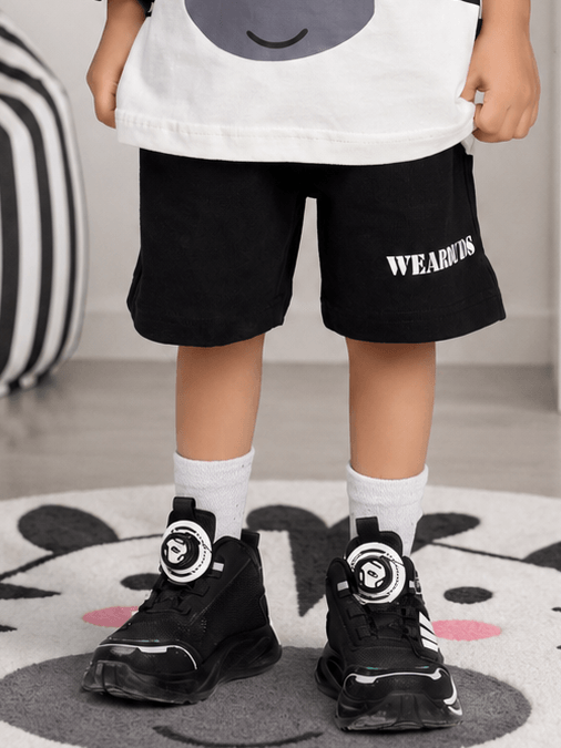 ZIPPY ZEBRA COOL SHORTS FOR BOYS GIRLS BLACK worn by a child, paired with stylish black sneakers.