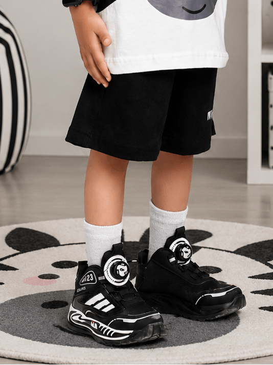 Kid wearing ZIPPY ZEBRA COOL SHORTS FOR BOYS GIRLS BLACK paired with stylish black shoes.