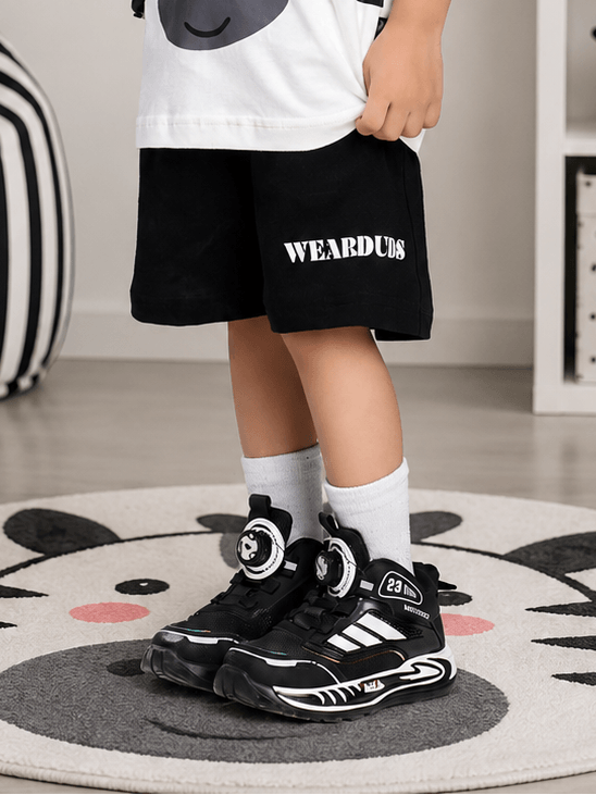 ZIPPY ZEBRA COOL SHORTS FOR BOYS GIRLS BLACK worn by a child with stylish black sneakers.