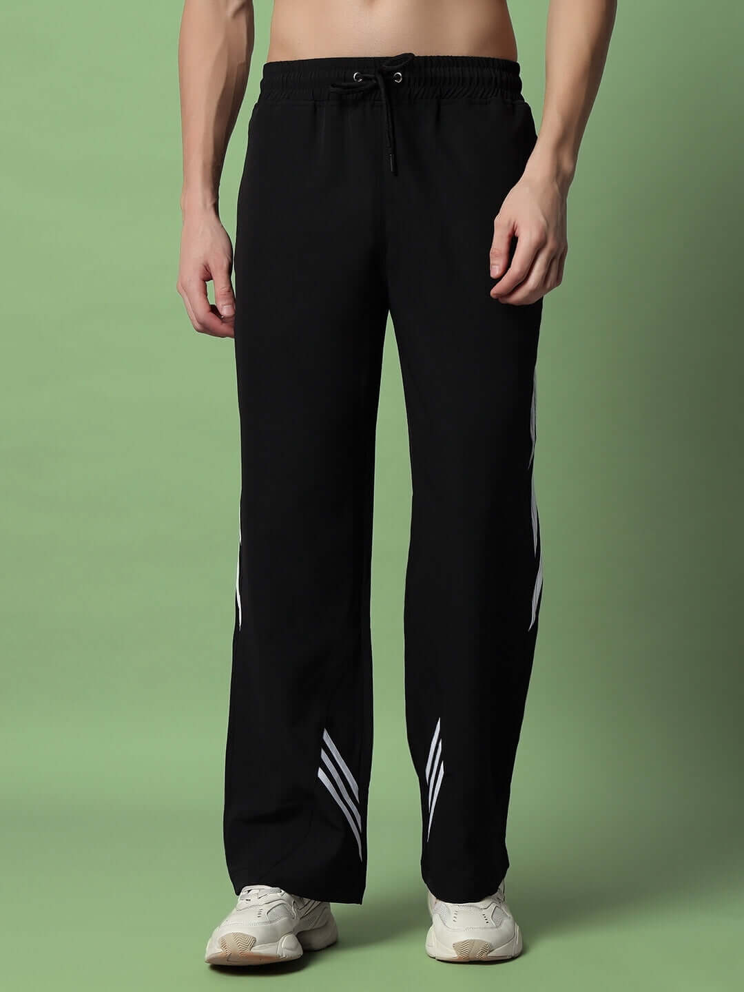 Man wearing Zoomer Relaxed Fit Cargo Pants in black, featuring a relaxed silhouette and side pockets, paired with white sneakers.
